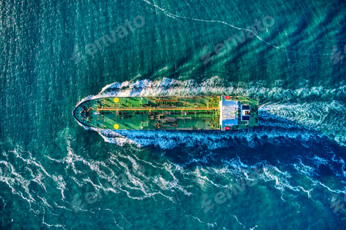 Preview: Aerial shot of an industrial ship sailing in the turquoise ocean