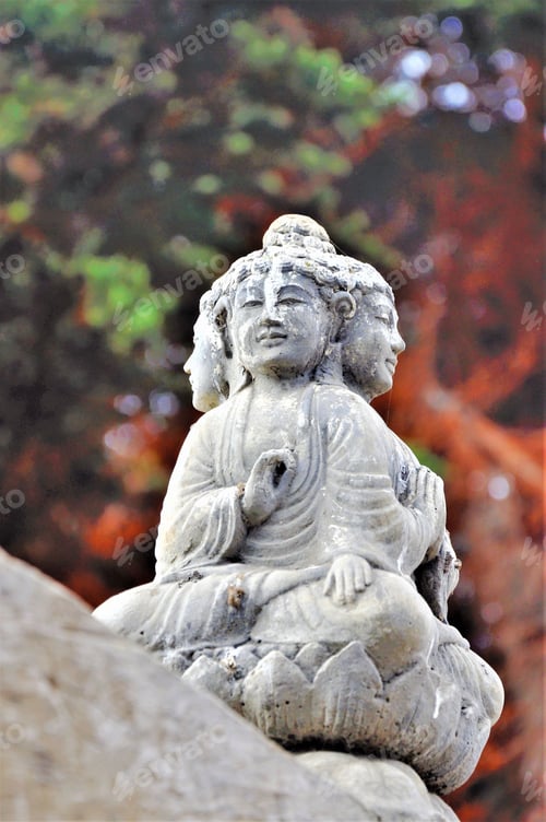 Preview: Vertical shot of a religious statue with stains of time engraved on stone