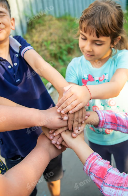 Preview: Children friends put their hands together. Selective focus.