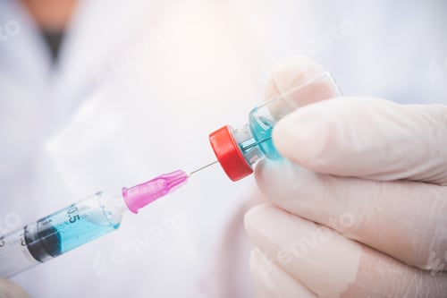 Preview: Doctor with syringe ready for injection of vaccine to patient. Vaccination concept.