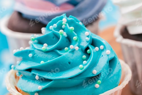 Preview: Side view of yummy cupcakes with assorted flavor. Shot on the table