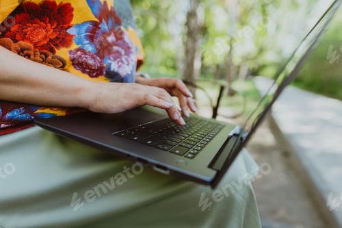 Preview: Office outdoors, close-up of female hands typing on keyboard with laptop