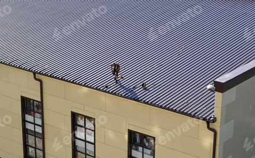 Preview: Unrecognizable roofer worker in uniform work wear using air or pneumatic nail gun and installing