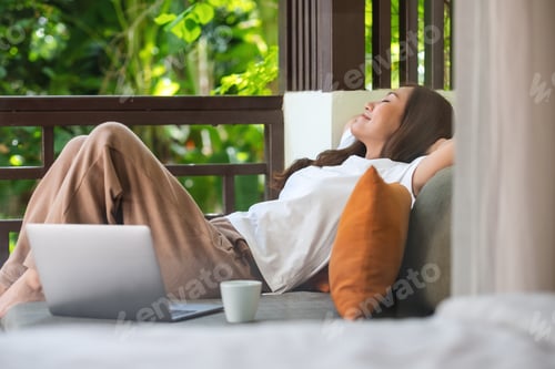 Preview: Relaxed Woman Resting on Couch Near Laptop
