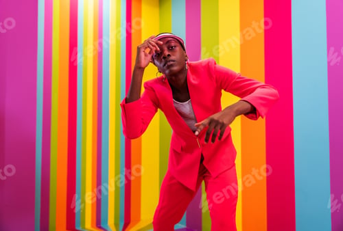 Preview: Beautiful young woman dancing and having fun inside a rainbow box room