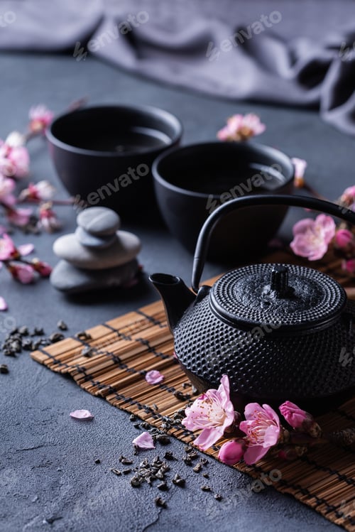 Preview: Teapot and tea cups with blooming almond tree branches