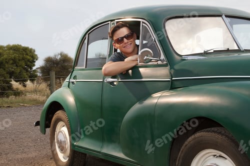 Preview: Portrait of young man in vintage morris minor