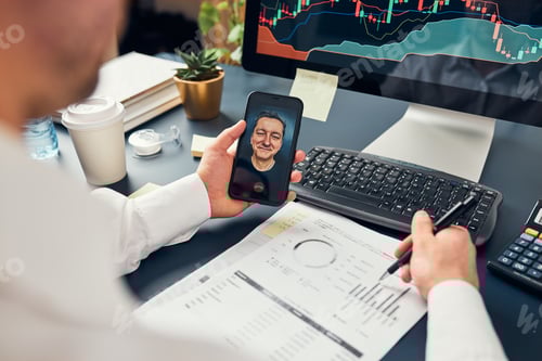 Preview: Businessman trading stocks online. Stock investor discussing numbers at graphs while video call