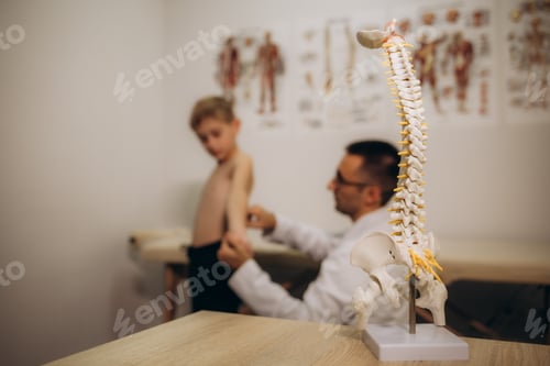 Preview: Chiropractor or osteopath does acupressure on back of child with back pain