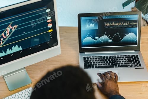 Preview: Crop black businessman typing on laptop