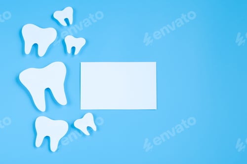 Preview: Paper cut mockup of tooth on blue background. Dental care concept. International Dentist Day.