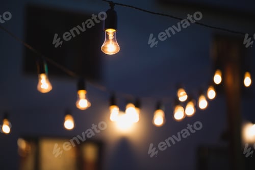 Preview: outdoor string lights hanging on a line in backyard