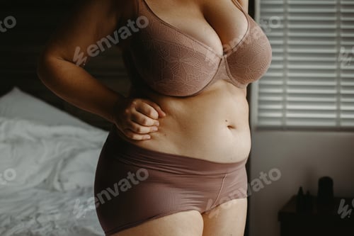 Preview: Confident caucasian female in lingerie in bedroom setting