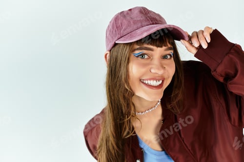 Preview: Young woman showcases trendy style with vibrant colors in modern indoor setting