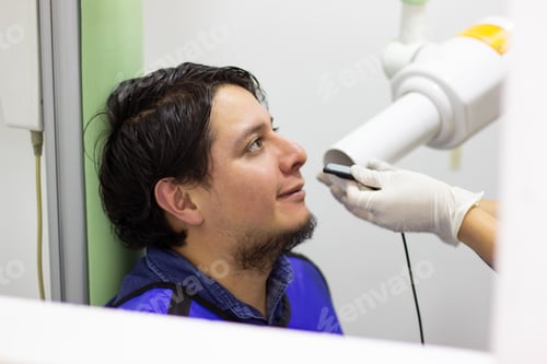 Preview: Male patient receiving a dental x-ray examination