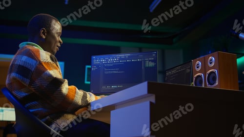 Preview: Black software engineer writes complex binary code scripts on computer