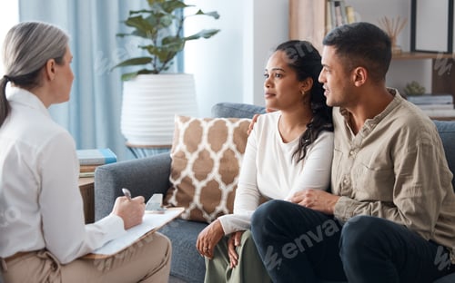 Preview: Shot of a happy young couple sitting together during a consultation with a psychologist