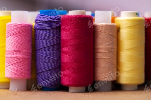 Preview: Many colored spools of threads as a background
