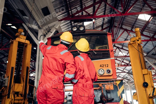 Preview: Team of engineer railway wearing safety uniform and helmet under checking under train.