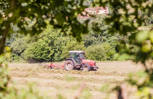 Preview: Tractor agricultural machinery equipment harvest a meadow in Asturias. rural farmer occupation