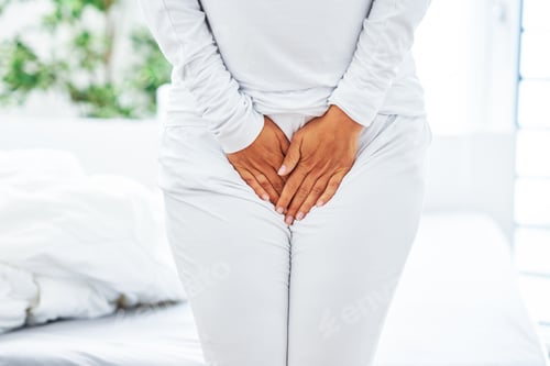 Preview: Young brunet woman with menstrual pain over bright bed