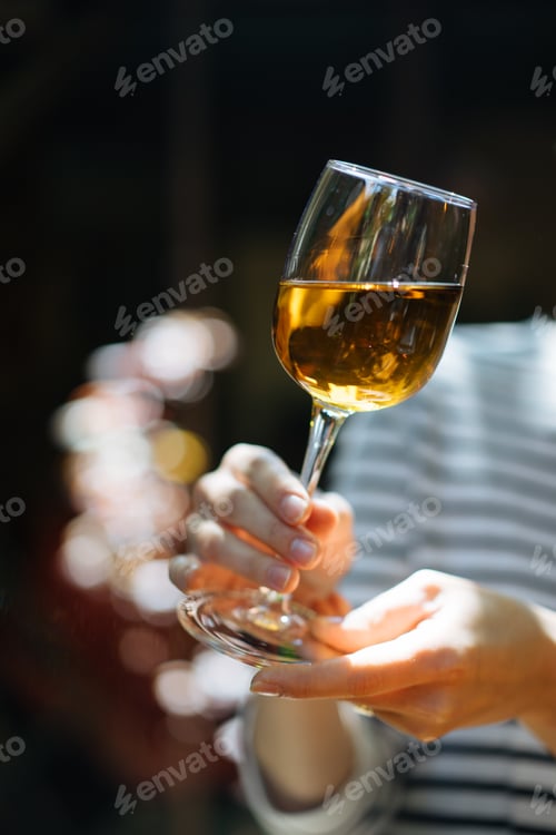 Preview: Woman holding glass of wine