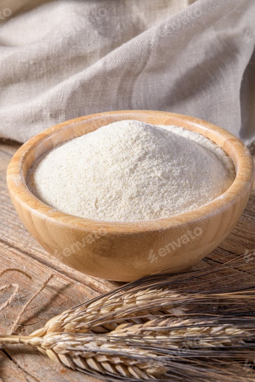 Preview: Whole wheat durum flour in wooden bowl on a wooden table