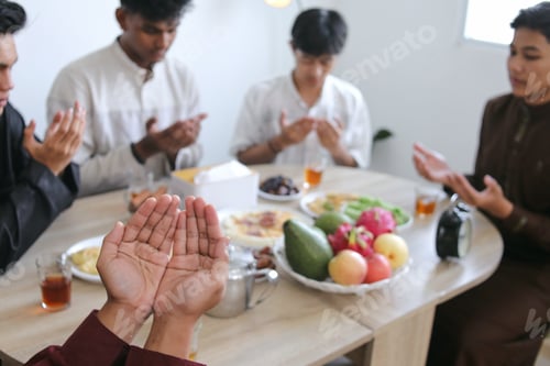 Preview: Selective Focus of Muslim Man Opening Arm Praying Before Breaking The Fast of Iftar on Ramadan
