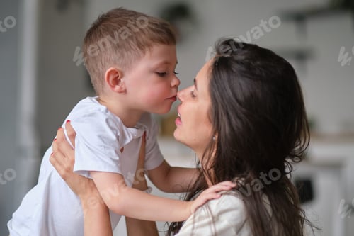Preview: little boy kiss his mother inside. cute baby kissing mom on the nose.