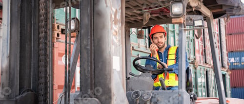Preview: Engineer or foreman working and use talkie with a forklift in at container yard.