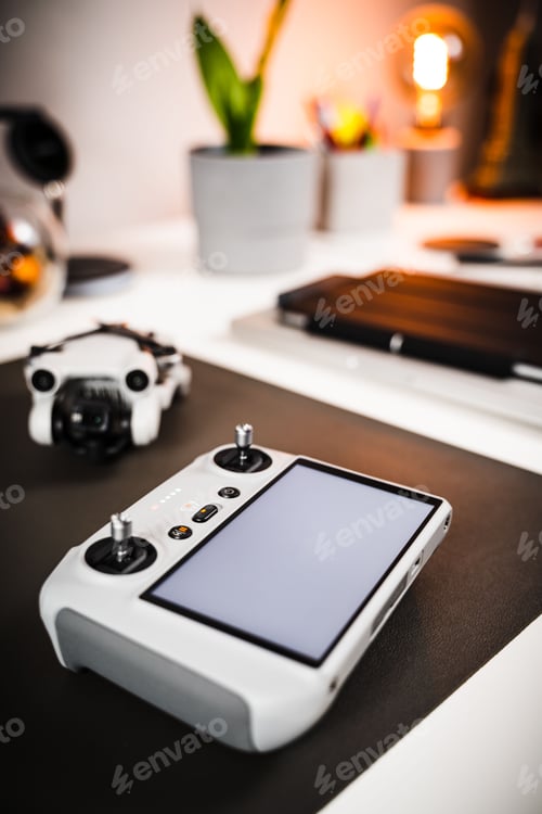 Preview: Vertical closeup of a game system on a desk with remotes