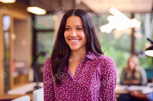 Preview: Portrait Of Smiling Businesswoman Standing In Modern Open Plan Office