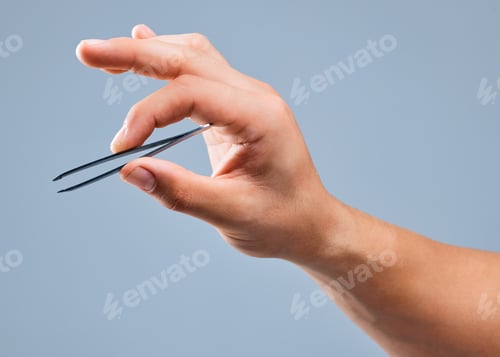 Preview: Shot of an unrecognizable man holding a tweezer against a white background