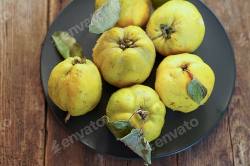 Preview: Quince fruit. Still life on a wooden background. Ripe quince fruits.