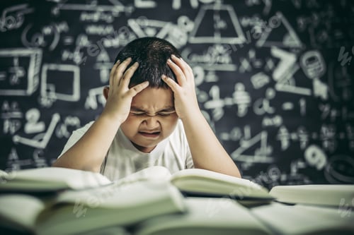 Preview: Boys with glasses write books and think in the classroom