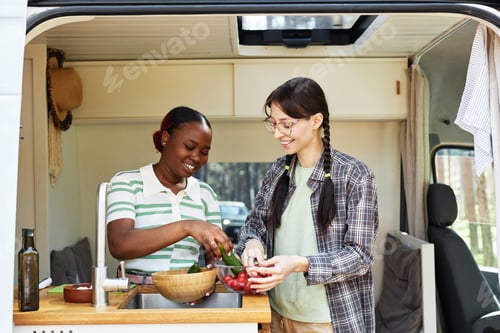 Preview: Girls washing vegetables for salad together
