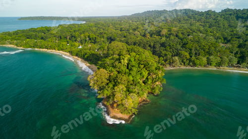 Preview: Alush green tropical island surrounded by turquoise waters and dense forest in Punta Uva beach