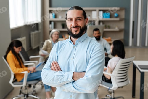 Preview: Confident businessman smiling with arms crossed in office meeting. Successful business concept
