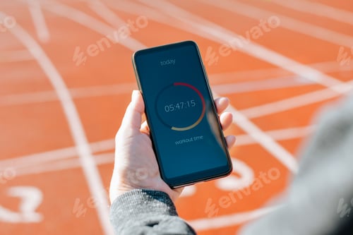 Preview: Close-up of woman using mobile application for workout . Training timer on smartphone screen