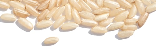 Preview: A background of dry brown rice grains showcases the integral, uncooked texture