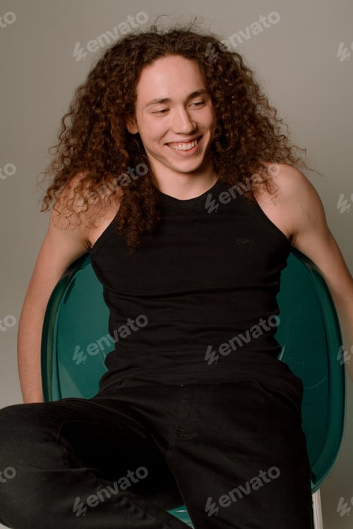 Preview: Attractive And Stylish Guy With Curly Hair And A Sports Figure