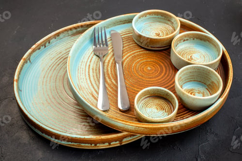 Preview: front view brown plates with fork and knife on dark background color table glass meal kitchen food
