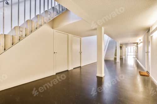 Preview: a long hallway with a staircase and white walls and