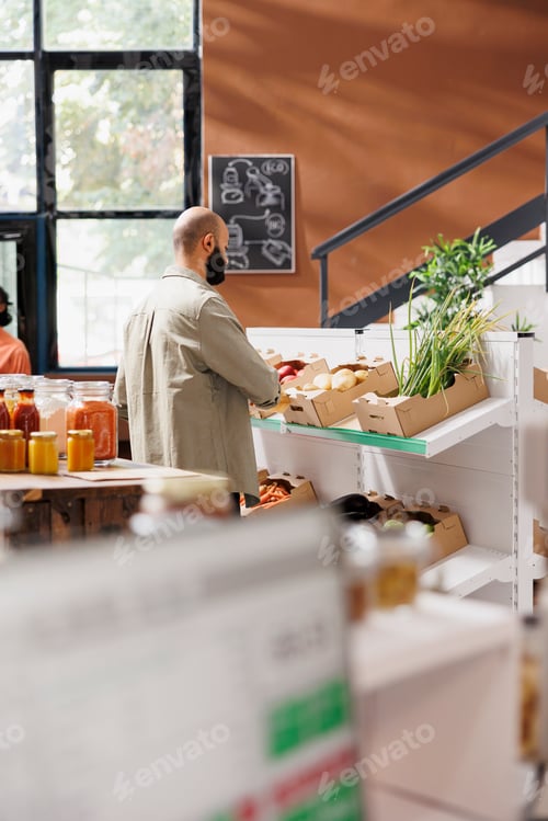 Preview: Man looking at various fresh produce