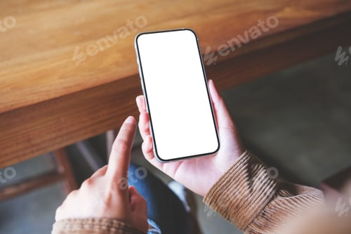 Preview: Mockup image of a woman holding and touching on mobile phone with blank desktop screen in cafe