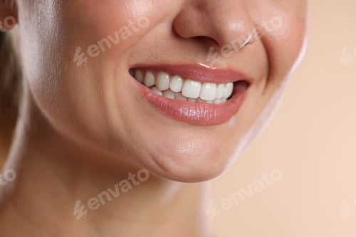 Preview: Woman with beautiful healthy teeth on beige background, closeup