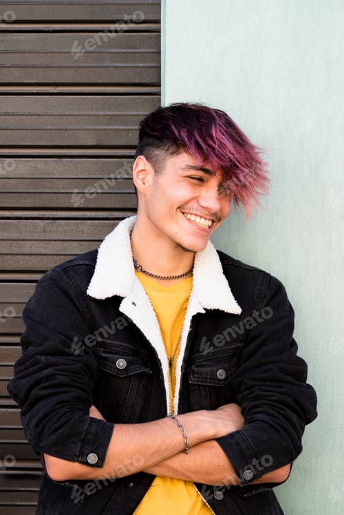 Preview: Vertical photograph of a young student dressed casually and having fun outdoors in the city.