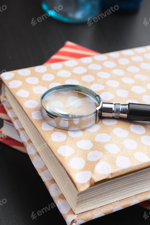 Preview: book and magnifying glass on wooden background