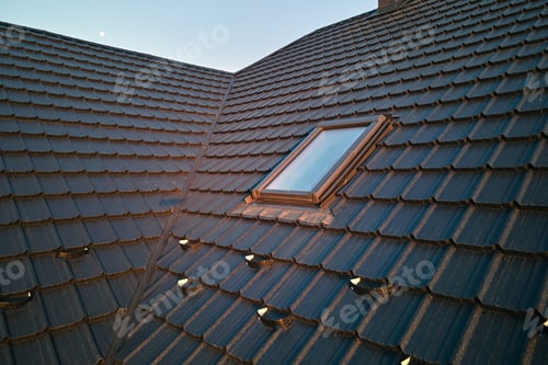 Preview: Closeup of attic window on house roof top covered with ceramic shingles. Tiled covering of building
