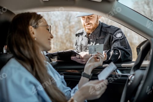 Preview: Policeman checking documents of a female driver